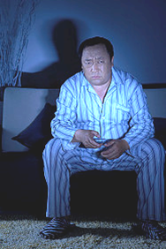 man watching tv late at night