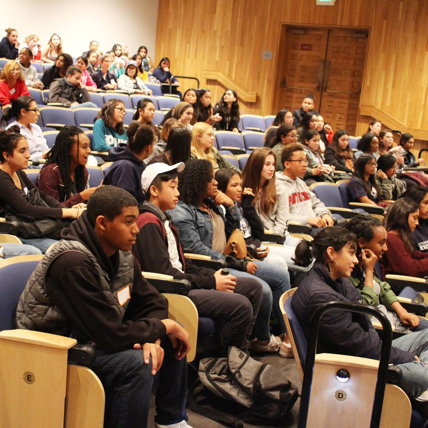 Students in the auditorium watching the welcome presentation.